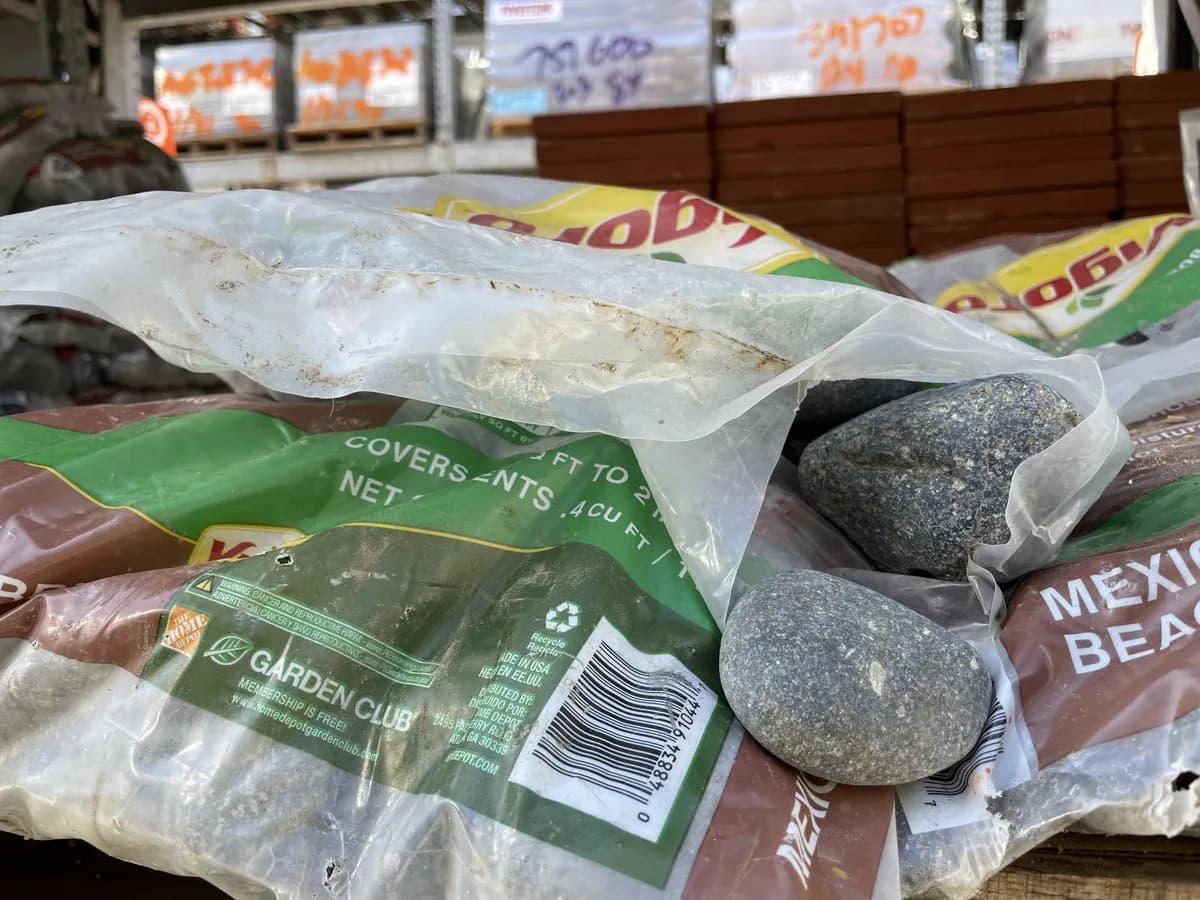 Split bag of Mexican beach pebbles with stones coming loose