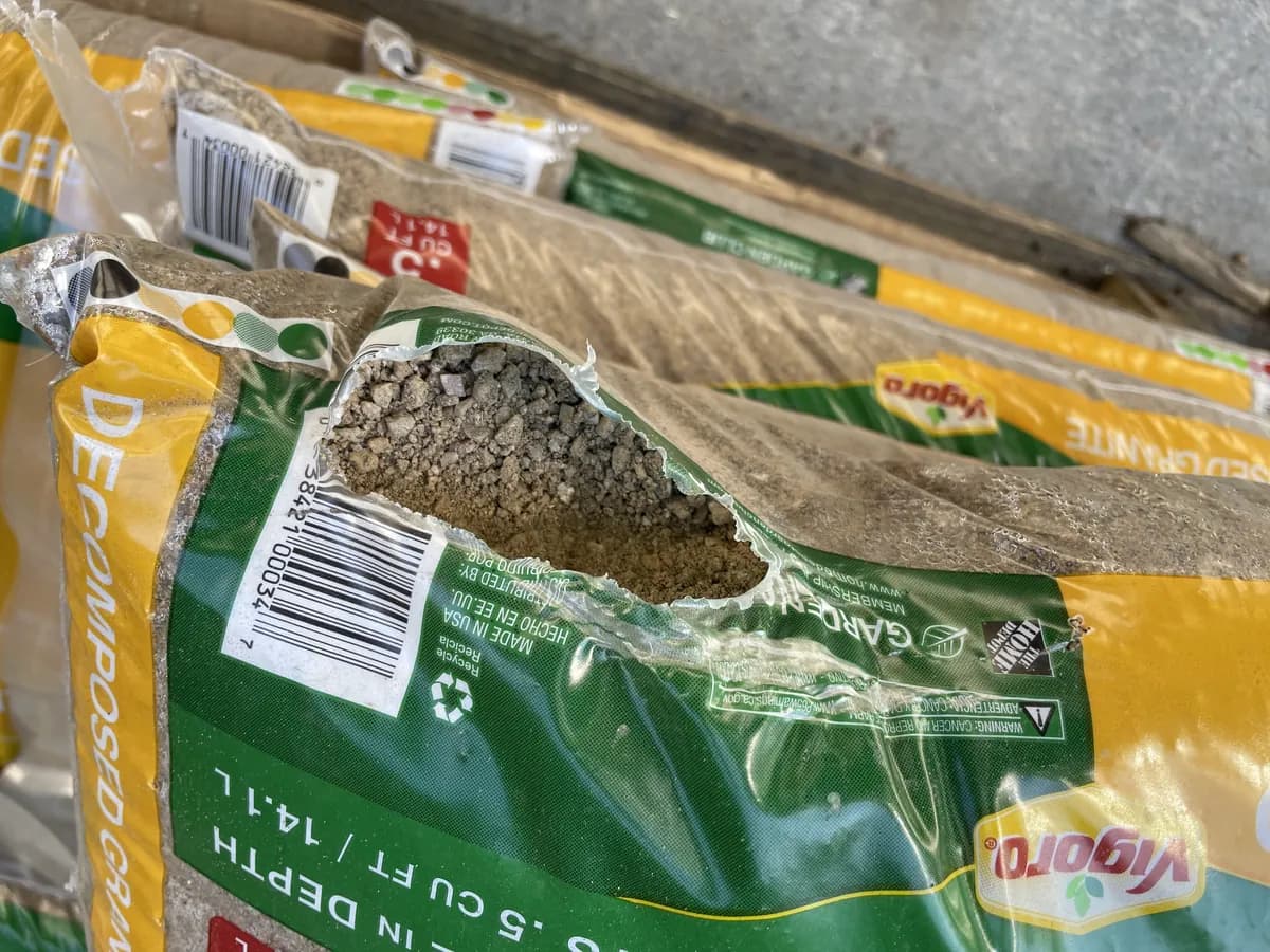 Bag of decomposed granite gashed along the top seam
